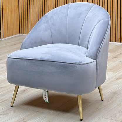 Cali bluish grey velvet accent chair against a slatted wooden wall on a light oak floor