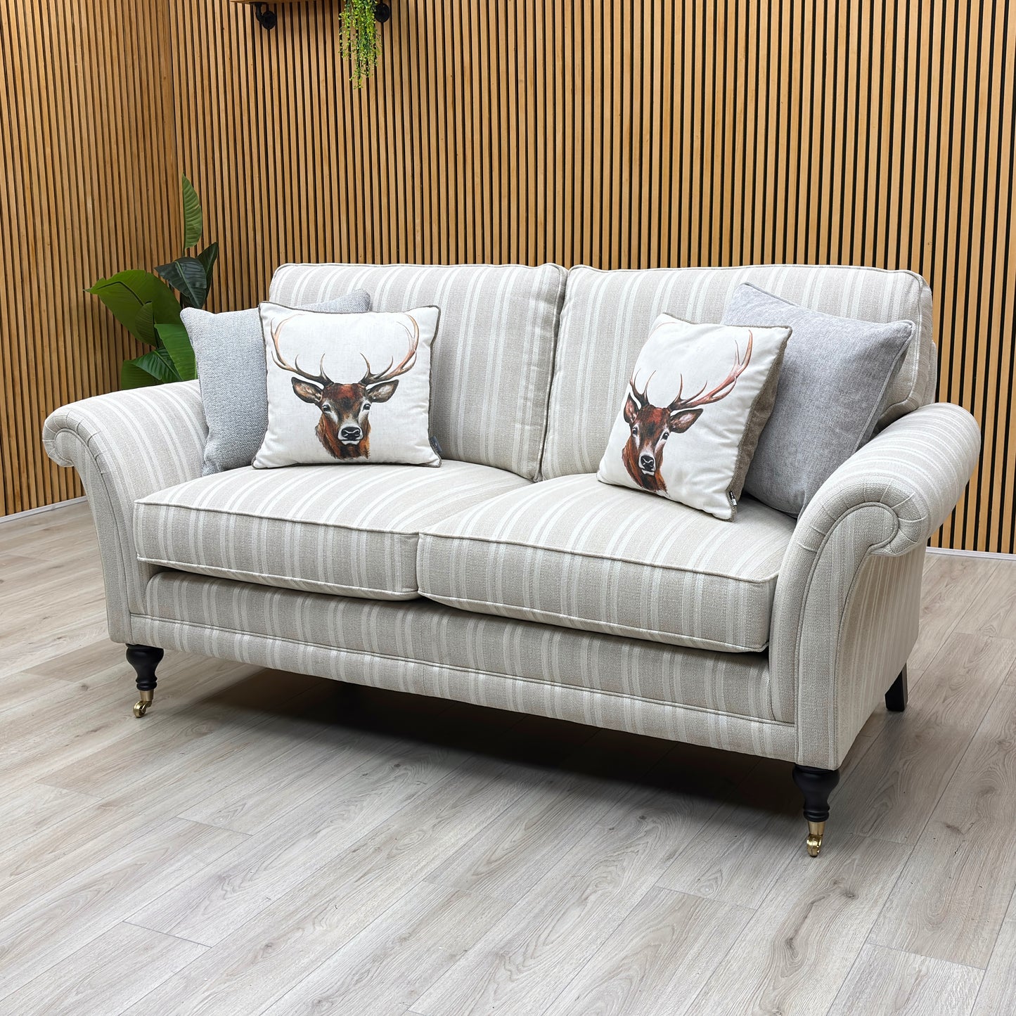 Lifestyle view of the Parker Knoll Burghley large 2-seater couch, illustrating the sweep of the scroll armrests, supportive backrest rake, and structural frame depth.