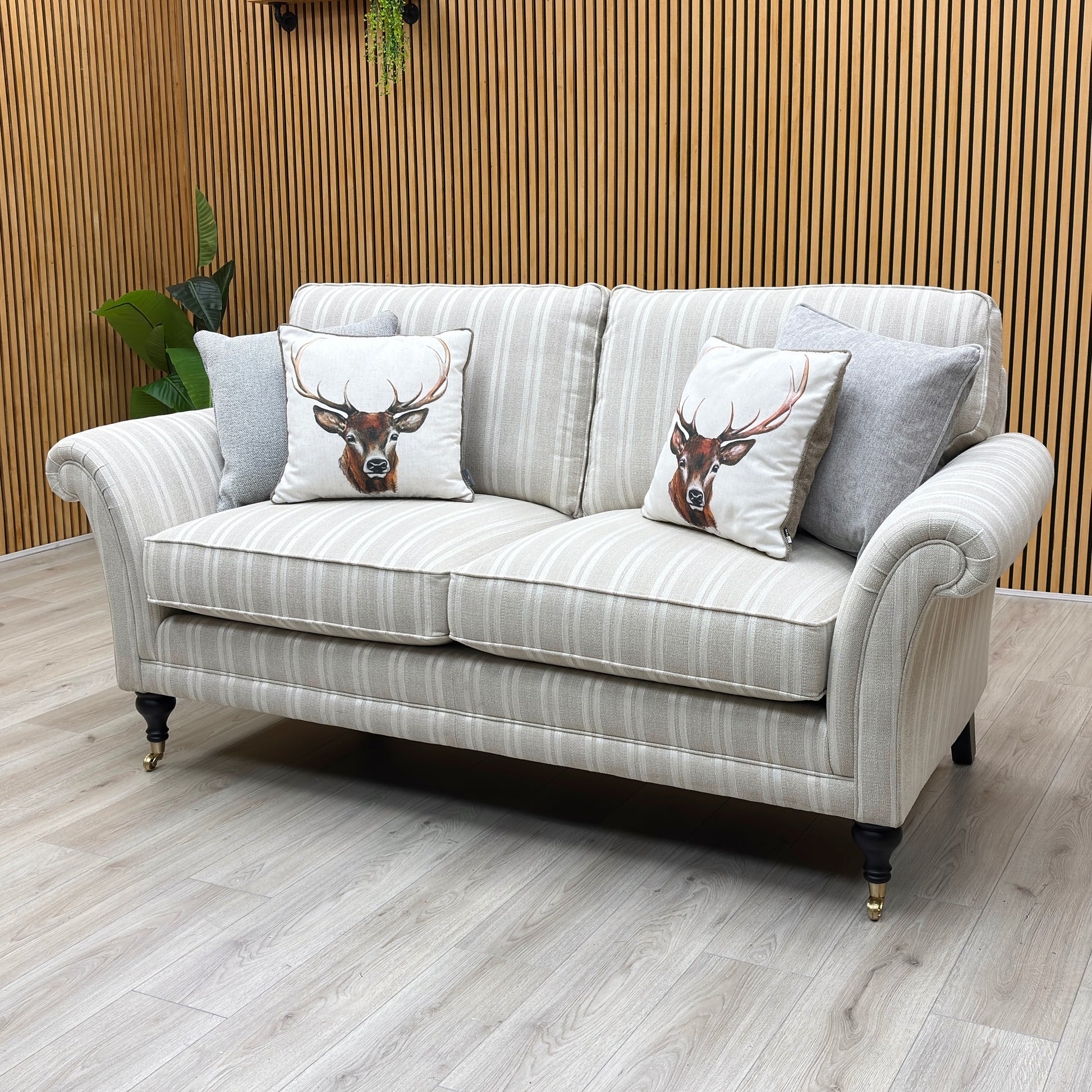 Lifestyle view of the Parker Knoll Burghley large 2-seater couch, illustrating the sweep of the scroll armrests, supportive backrest rake, and structural frame depth.
