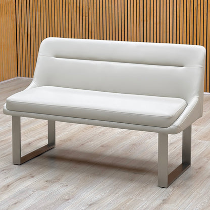 Avorio neutral faux leather high back dining bench against a slatted wooden wall on a light floor