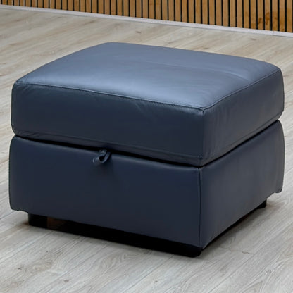 World of Leather Touch ocean blue leather storage footstool on a pale wood floor by a slatted wooden wall