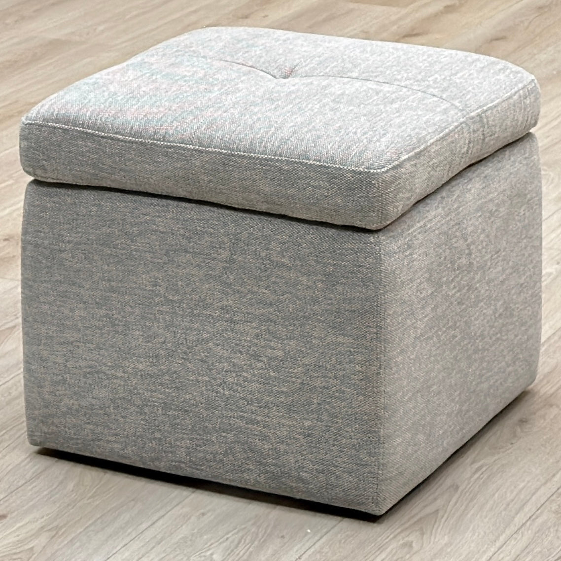 Easy Tray wild dove grey fabric storage footstool on a light oak floor, angled view
