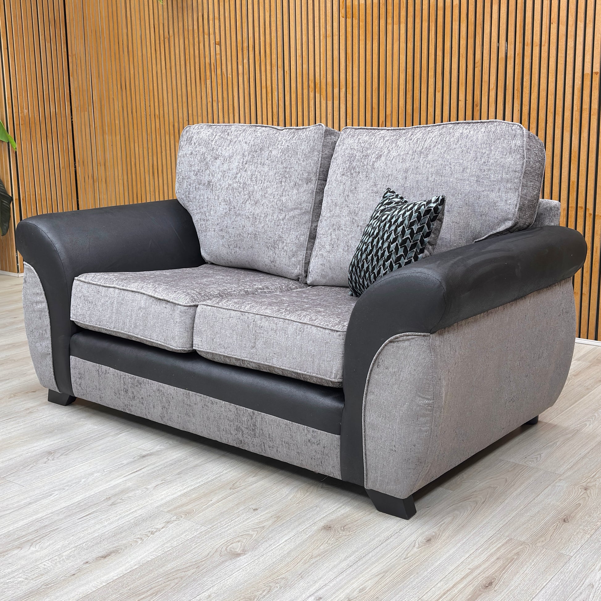 Lifestyle shot of the Marino’ grey sofa in a modern living room, showcasing its versatile style and comfortable proportions.