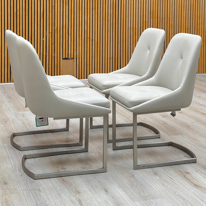 Set of 4 Avorio neutral faux leather cantilever dining chairs against a slatted wooden wall