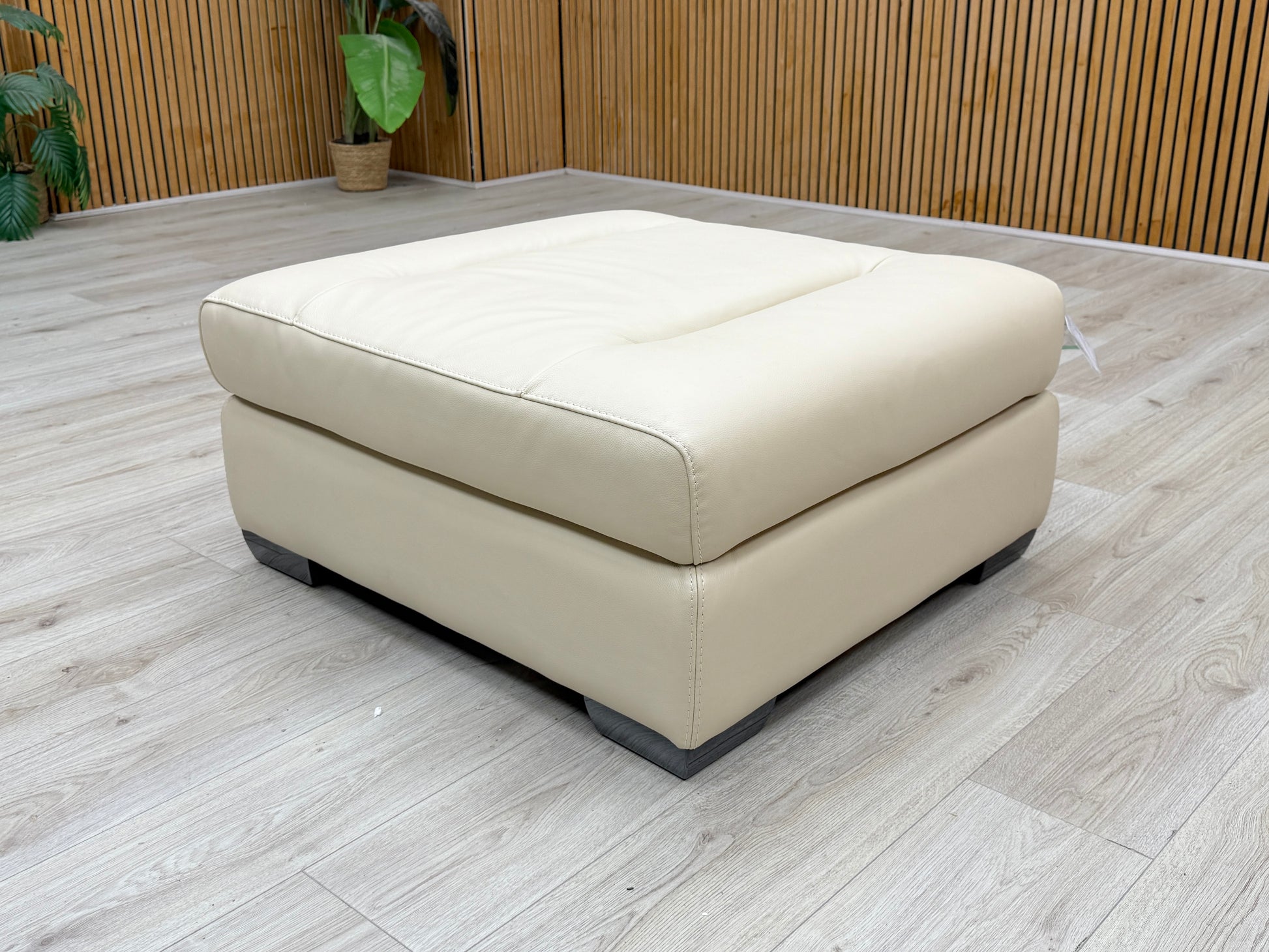 Three-quarter studio perspective showcasing the full expansive width and substantial profile of the large square footstool, demonstrating its low-profile modern design.