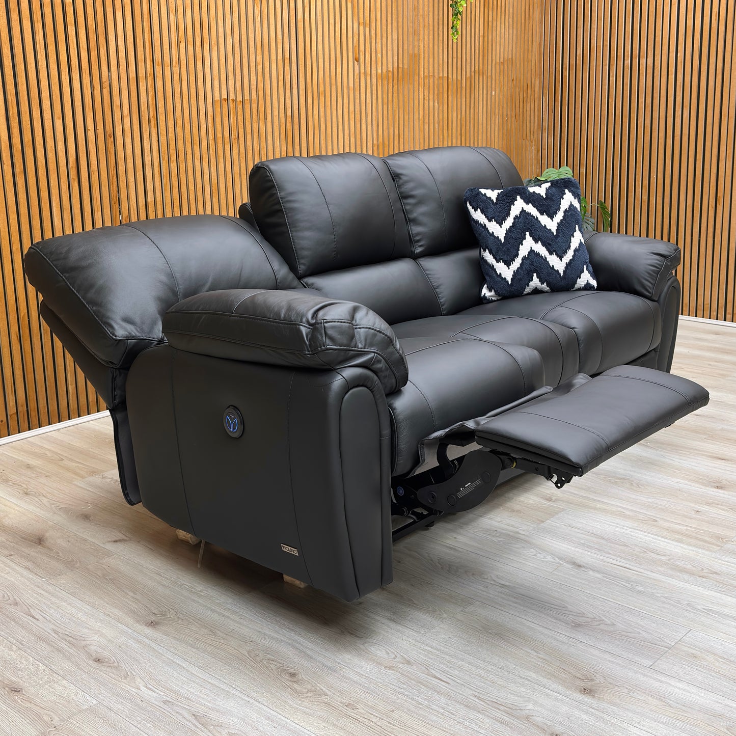 Lifestyle shot of the ‘Leighton’ 3 seater sofa in a contemporary lounge, showcasing its sleek black finish and comfortable seating.
