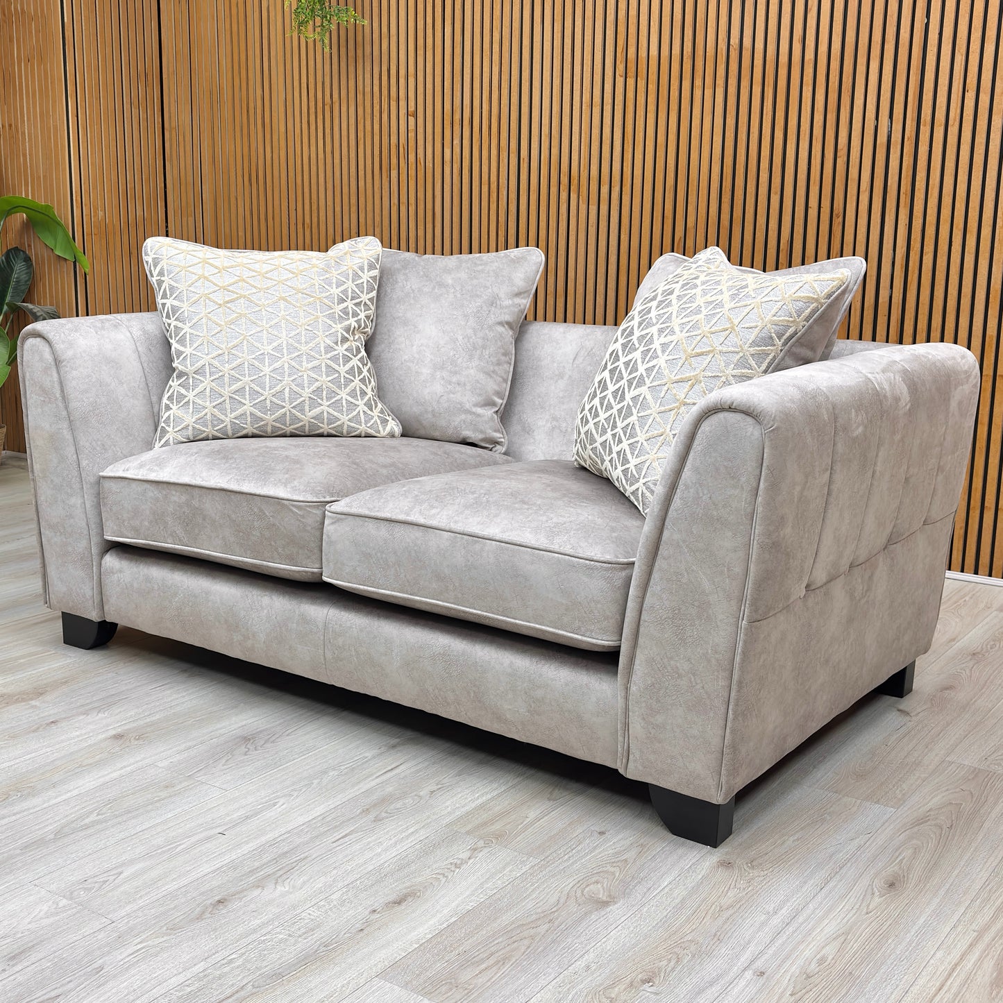 Lifestyle view of the Mariah Dapple Velvet 2-seater scatter back sofa in cream, featuring a plush textured finish and dark wooden feet.
