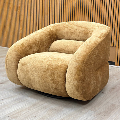 Lifestyle view of the mustard yellow swivel chair, highlighting its compact design and deep-cushioned seating.
