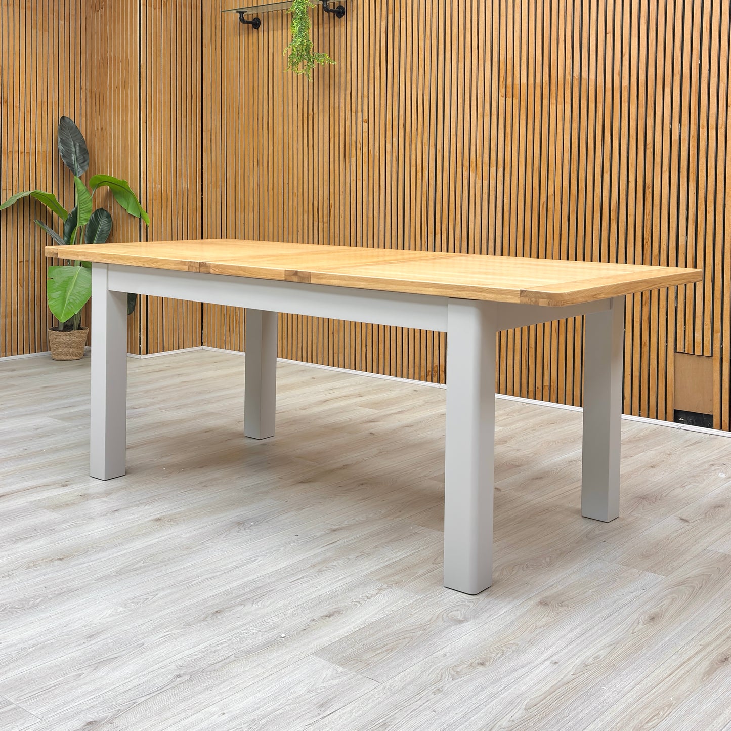 Lifestyle view of the ‘Lewis’ oak dining table, highlighting its clean lines and smooth surface.