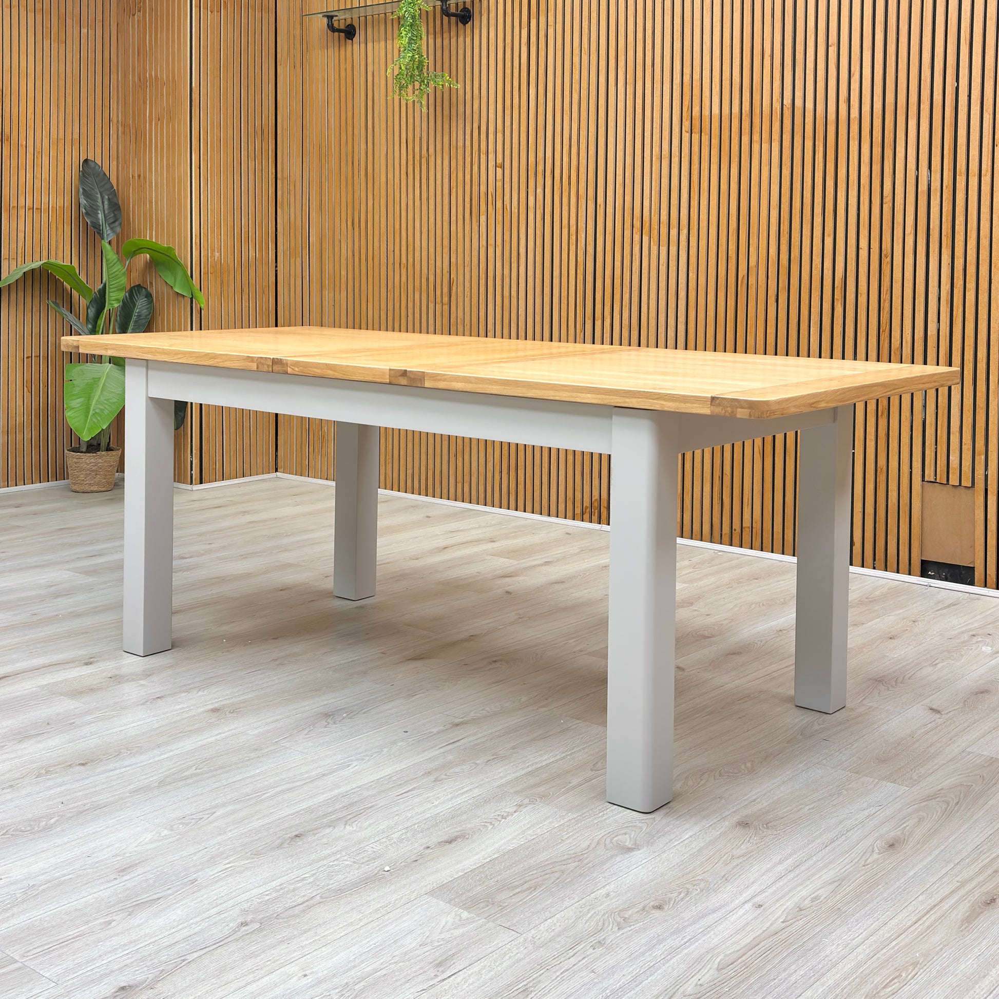 Lifestyle view of the ‘Lewis’ oak dining table, highlighting its clean lines and smooth surface.