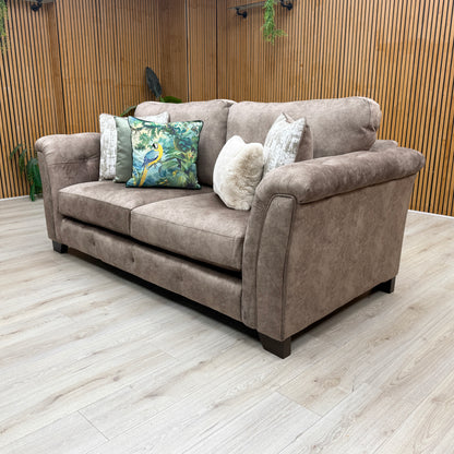 Lifestyle view of the Aura fabric sofa frame, showing the clean lines of the armrest, upright backrest support angle, and solid foundational low-profile feet.