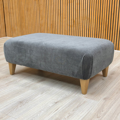 Stylized lifestyle shot of the ‘Soho’ Garda Carbon footstool highlighting the spacious, flat upholstered top surface.