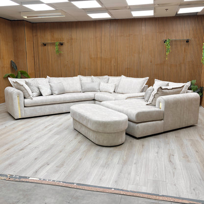 Stylized lifestyle shot of the Savoy corner sofa, highlighting the elegant marble-effect upholstery and gold base detailing.