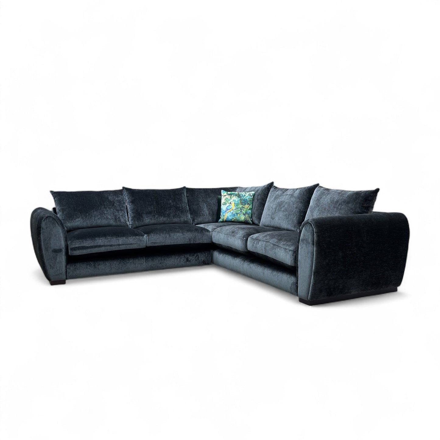 Maddison Dark Charcoal Grey Velvet 3-Seater Corner Sofa in a modern living room setting, showcasing its spacious L-shape design.