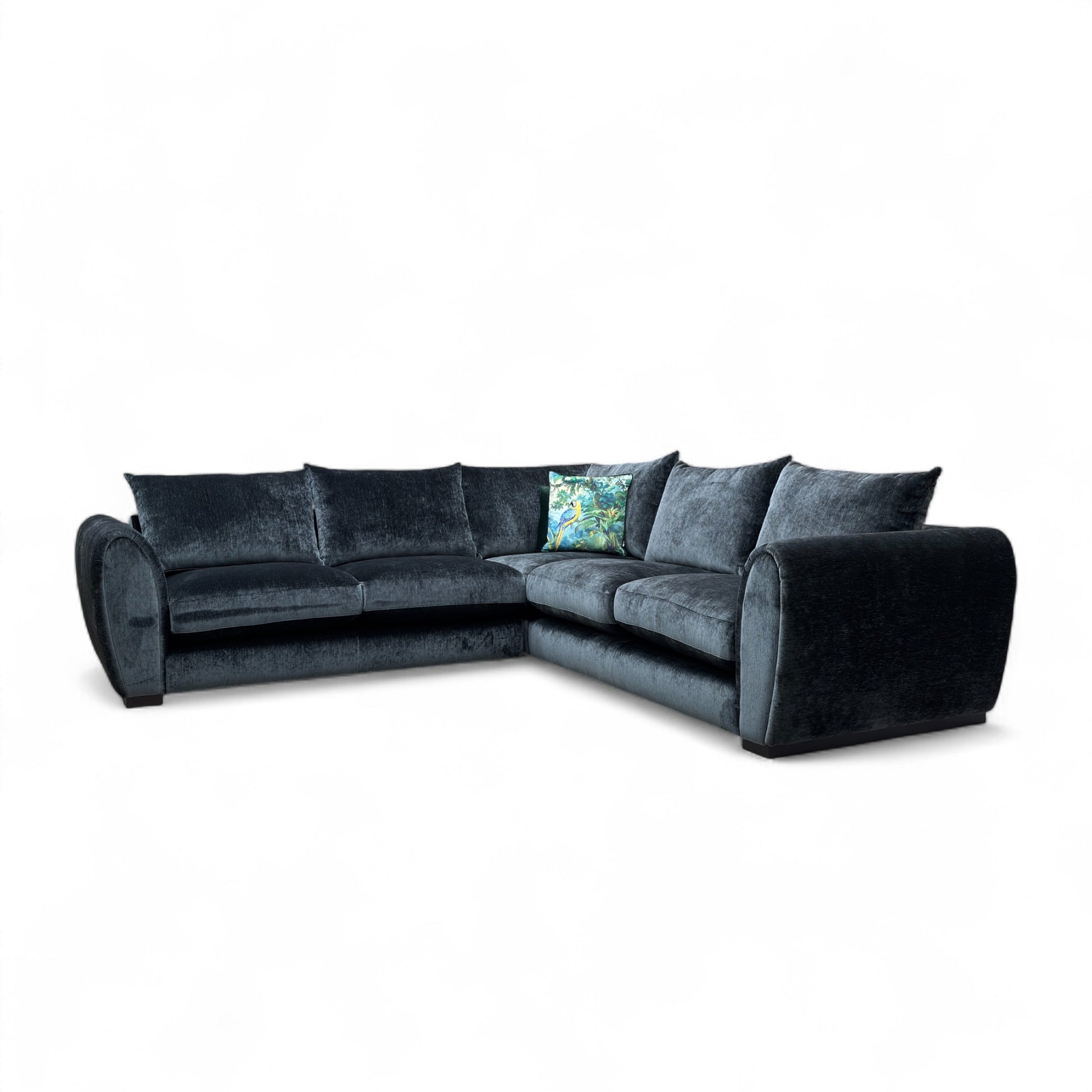 Maddison Dark Charcoal Grey Velvet 3-Seater Corner Sofa in a modern living room setting, showcasing its spacious L-shape design.