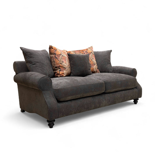 Gray sofa with patterned pillows on a white background