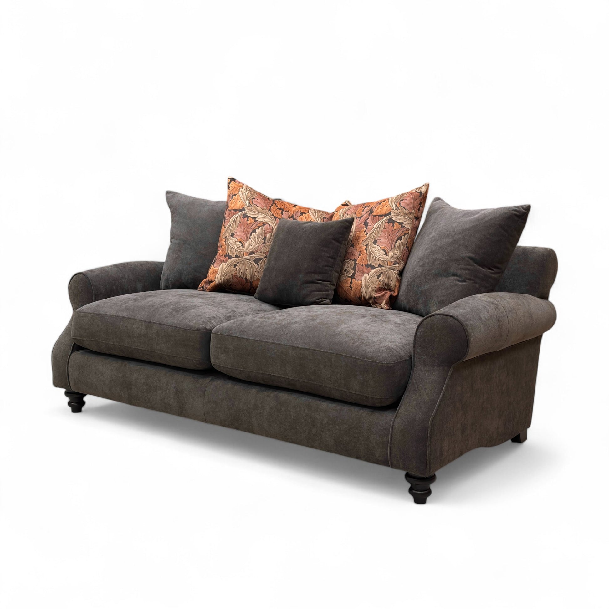 Gray sofa with patterned cushions on a white background