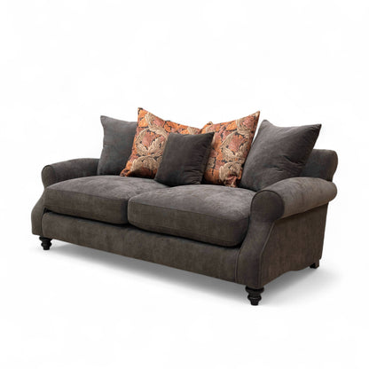 Gray sofa with patterned cushions on a white background