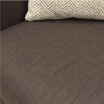 Brown textured fabric surface with a patterned pillow on top