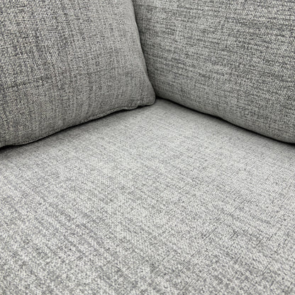 Close-up detail of the Sort Grey Woven Fabric upholstery, clearly showing the textured weave and neutral colour of the material.