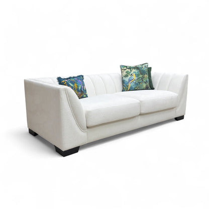 White sofa with decorative pillows on a white background