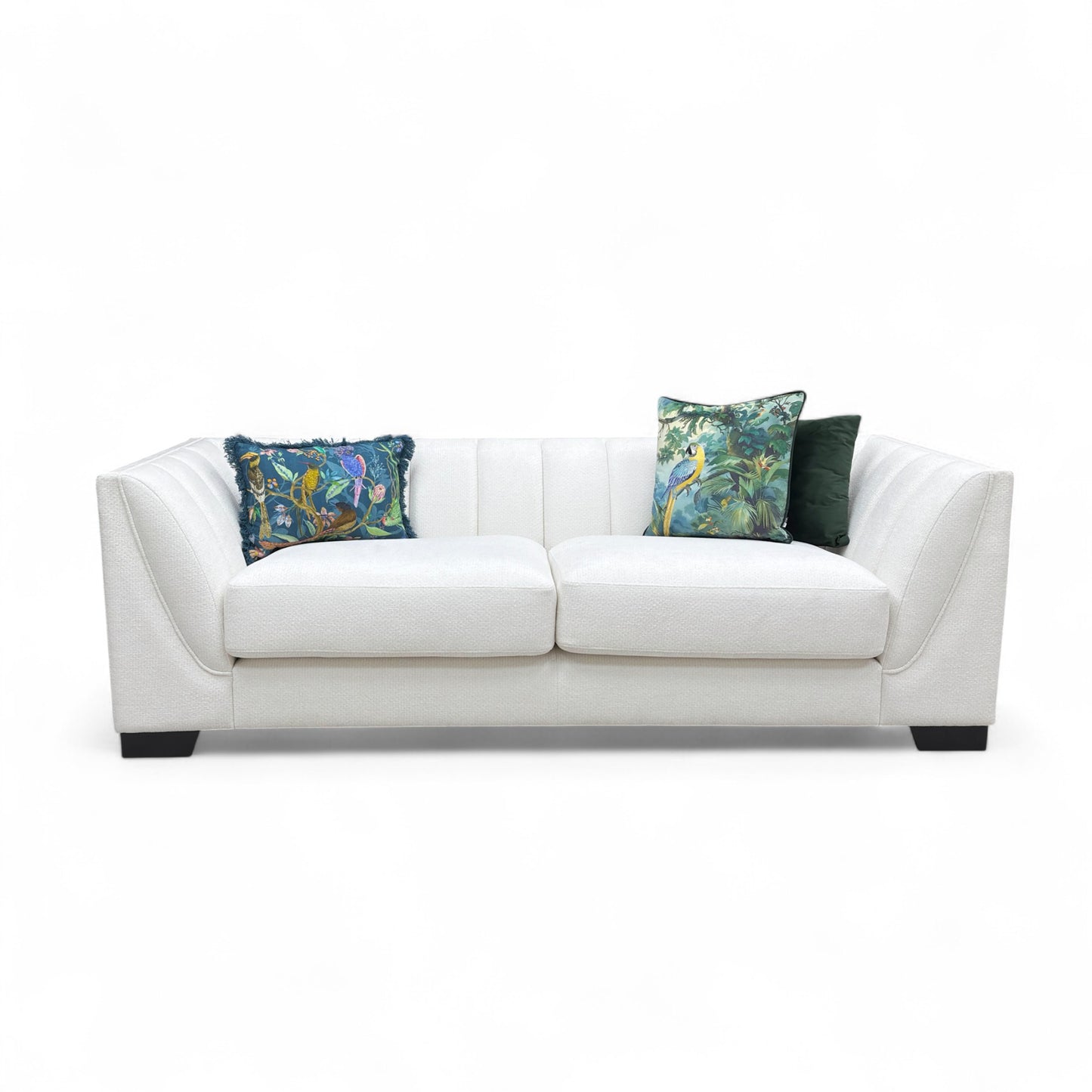 White sofa with floral-patterned cushions on a white background
