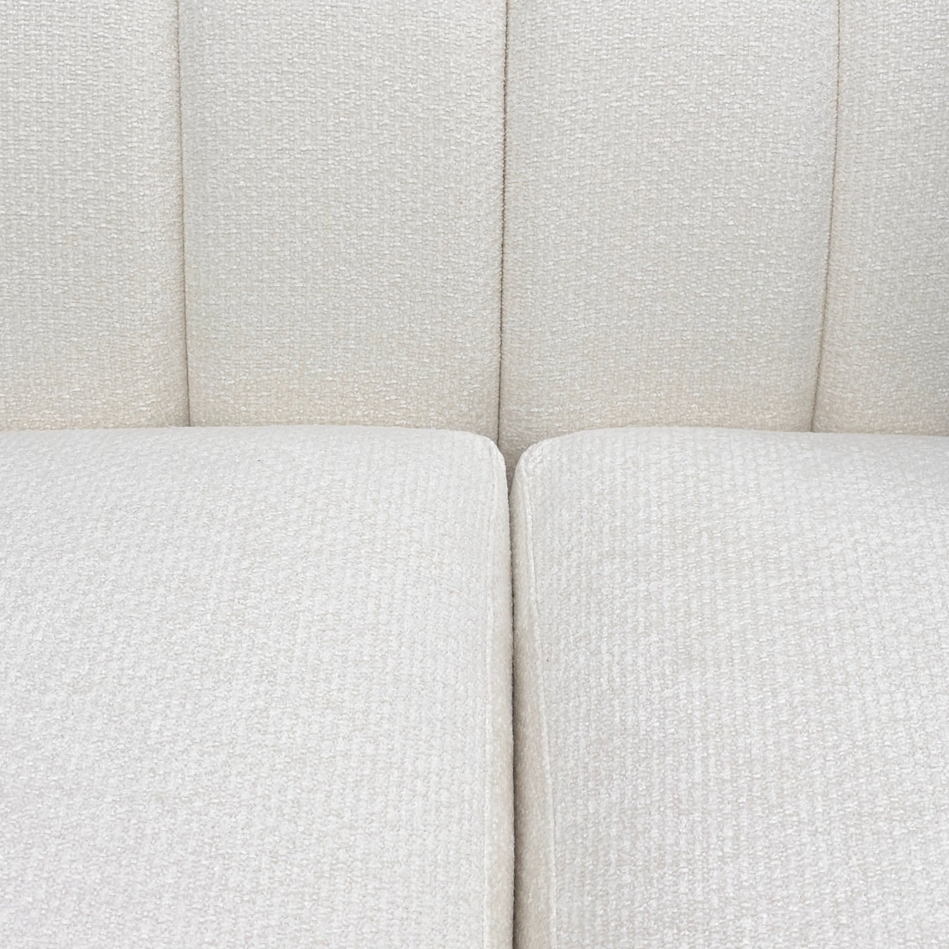 Close-up of a textured white sofa with a neutral color scheme.