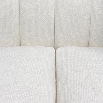 Close-up of a textured white sofa with a neutral color scheme.