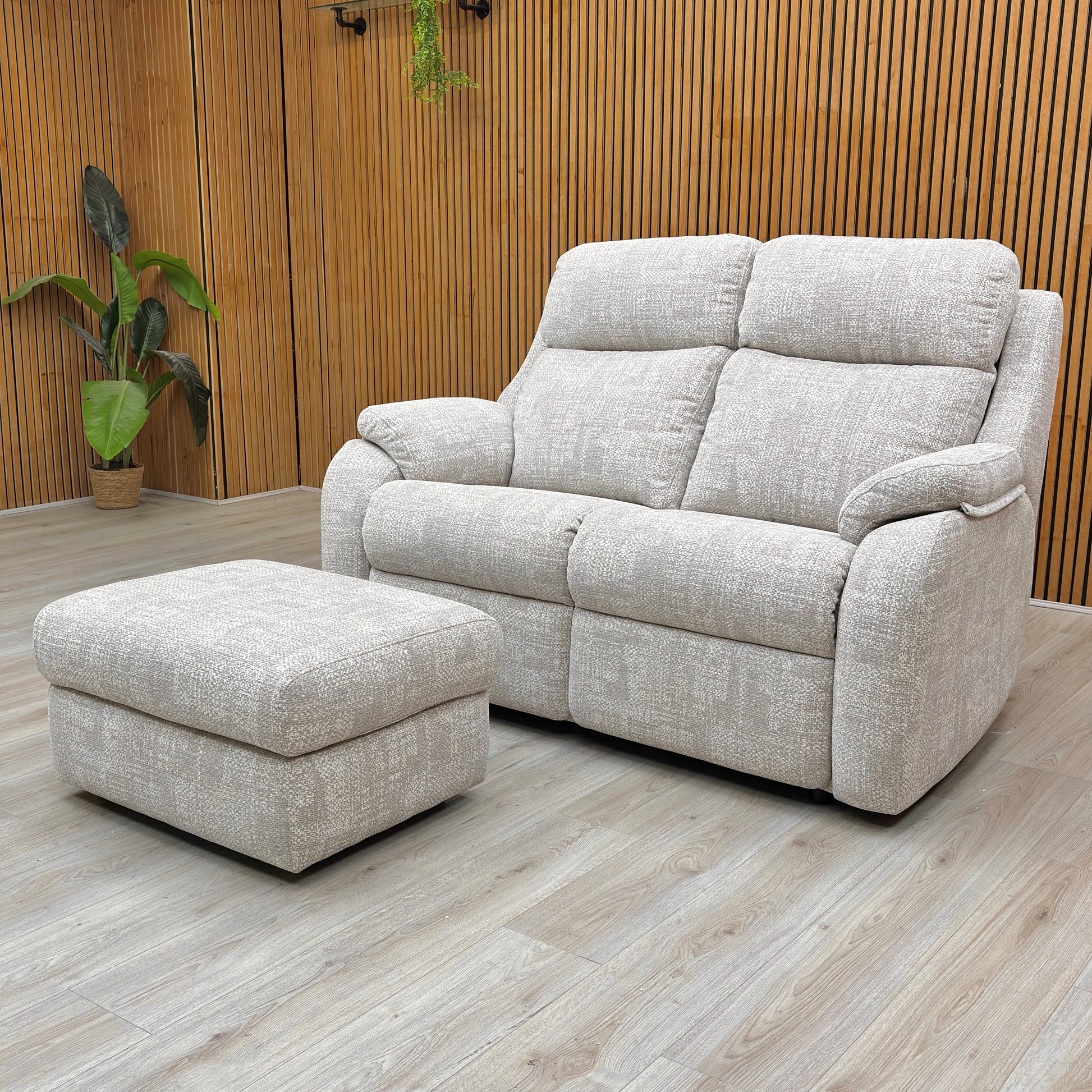 Lifestyle shot of the Kingsbury sofa and storage stool set, highlighting the high-back design and curved padded armrests.
