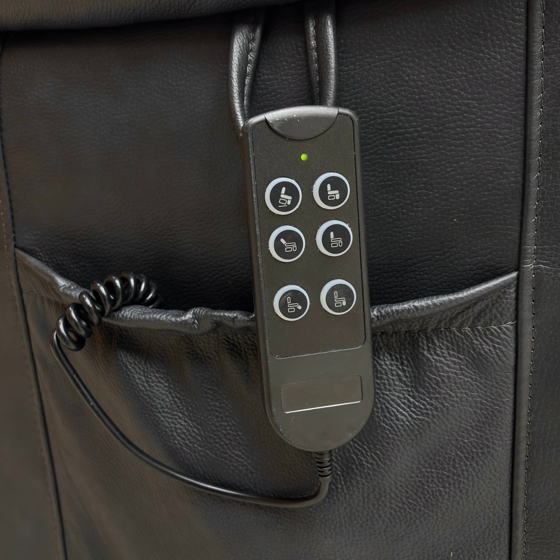 Control panel with buttons on a black leather surface