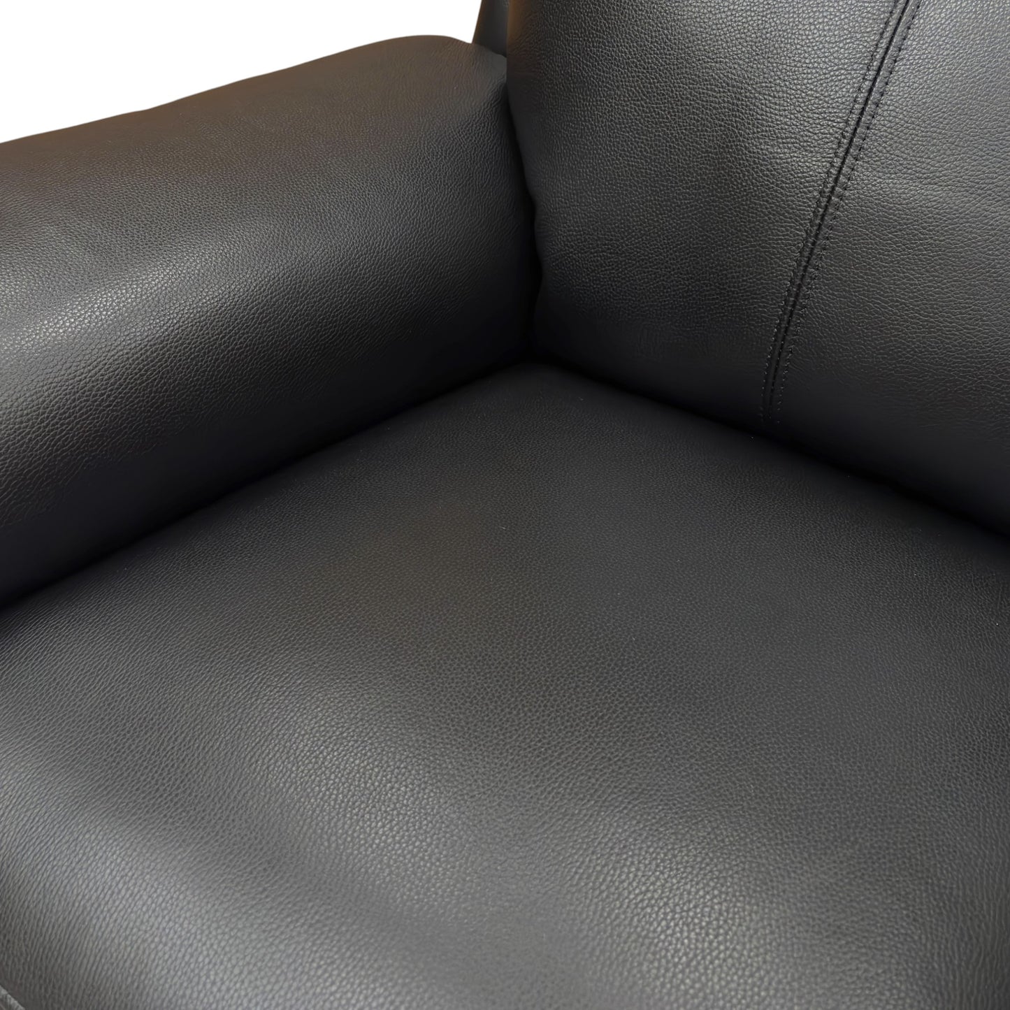 Close-up of a black leather sofa corner