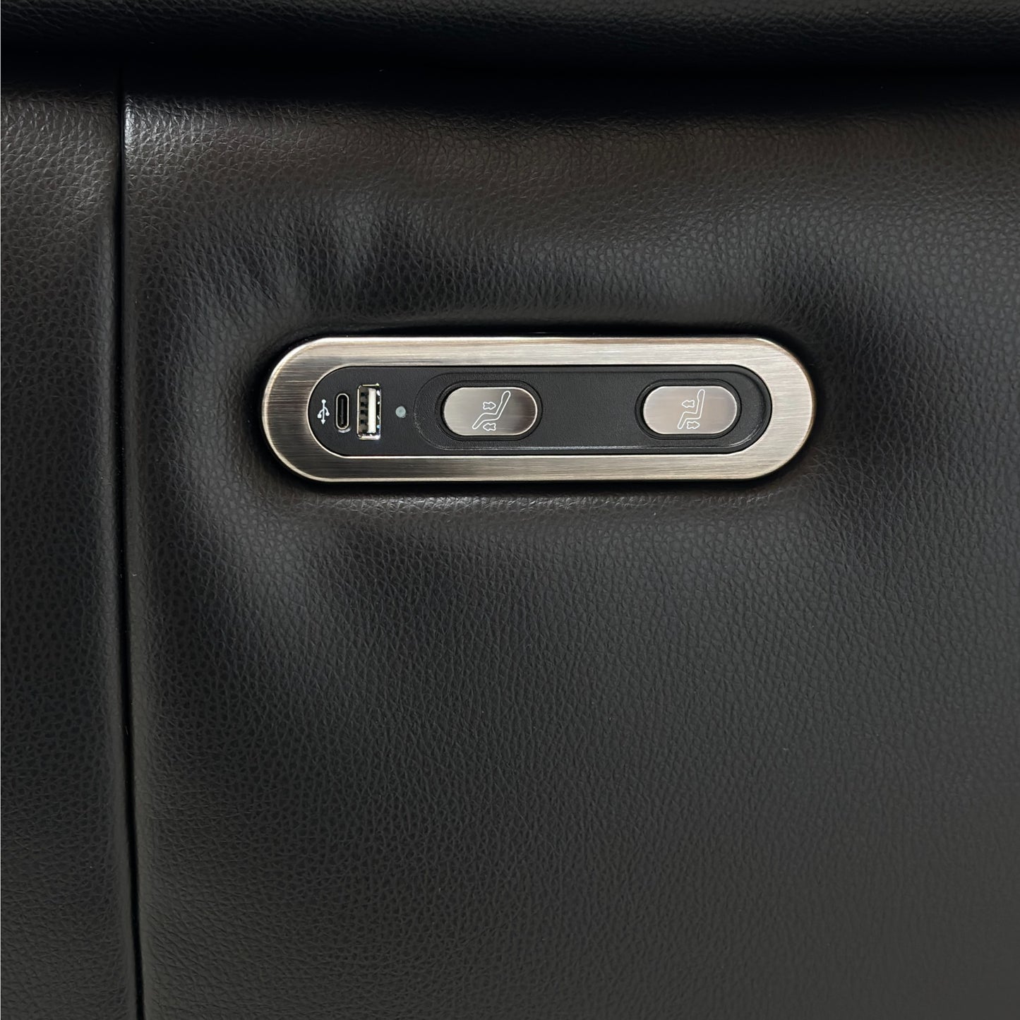 Black leather sofa with a USB charging port and power button 