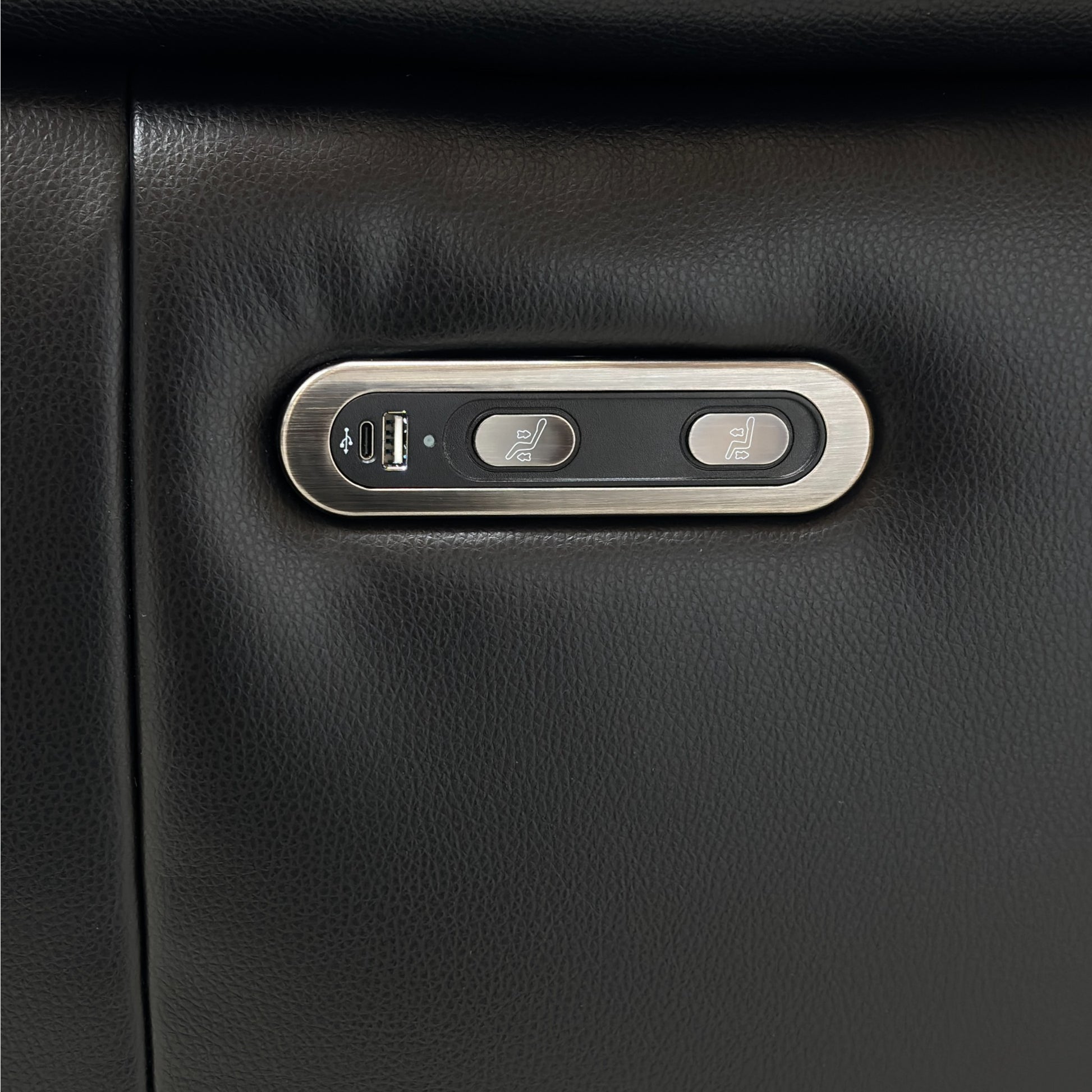 Black leather sofa with a USB charging port and power button 