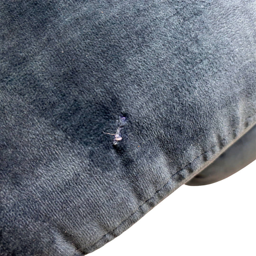 Close-up detail of the surface-level cosmetic imperfection on the airforce blue velvet cushion of the ‘Sloane’ Heritage sofa.