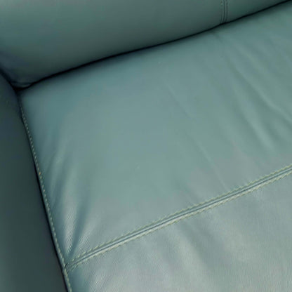 Close-up of a Green leather sofa with stitching detail
