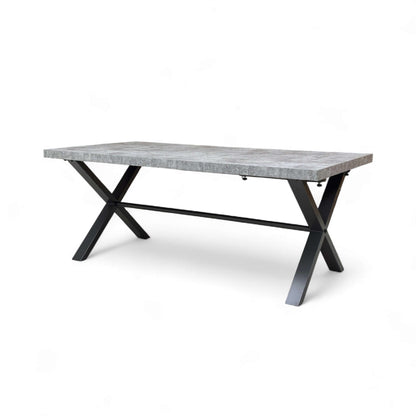 Rectangular dining table with concrete top and black metal legs on a white background
