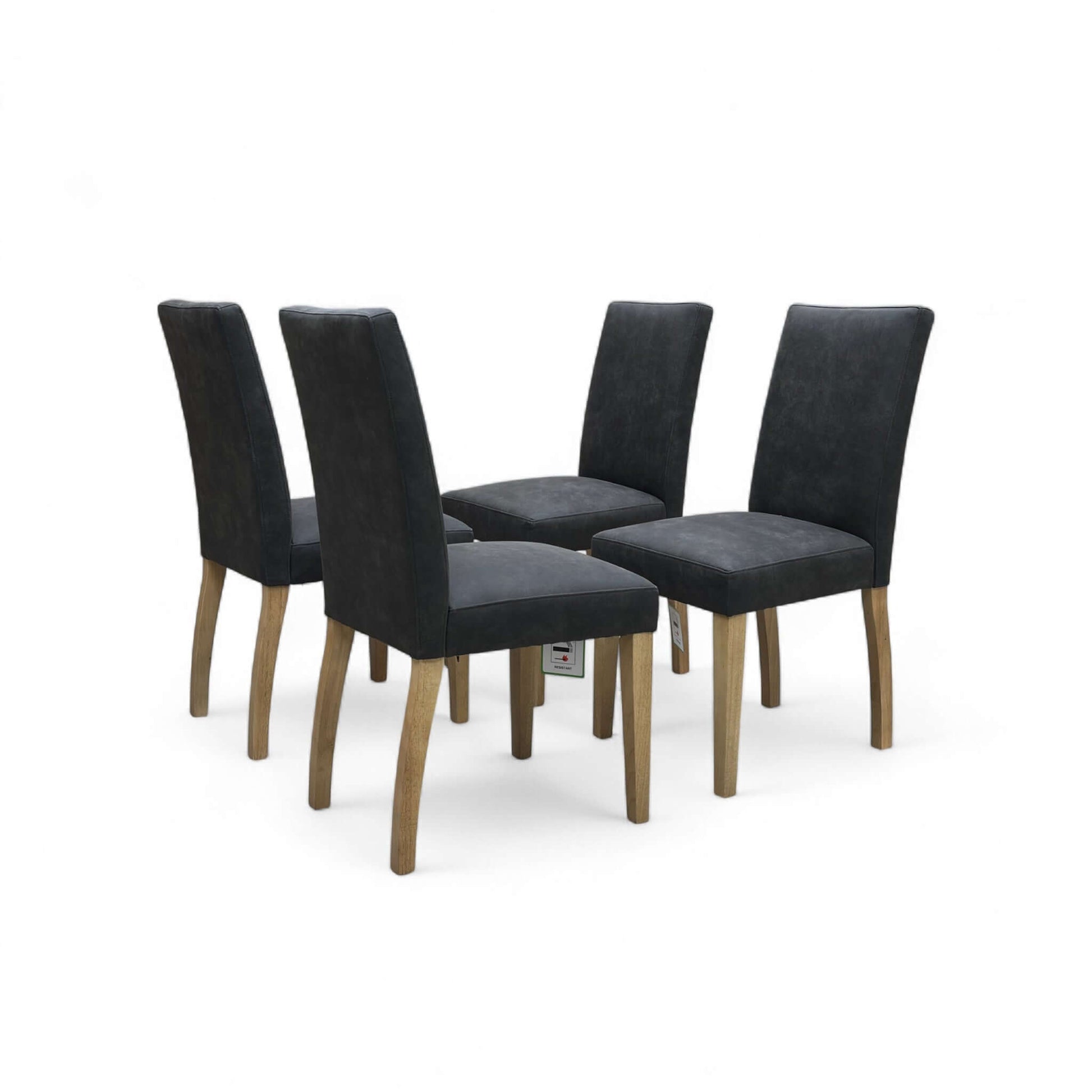 Four black upholstered chairs with wooden legs on a white background