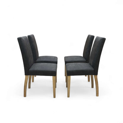 Four black chairs with wooden legs on a white background