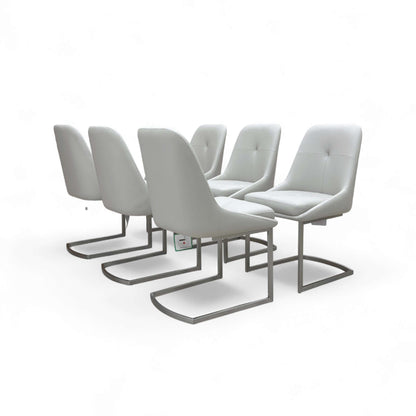 Set of six modern gray chairs with metal legs on a white background