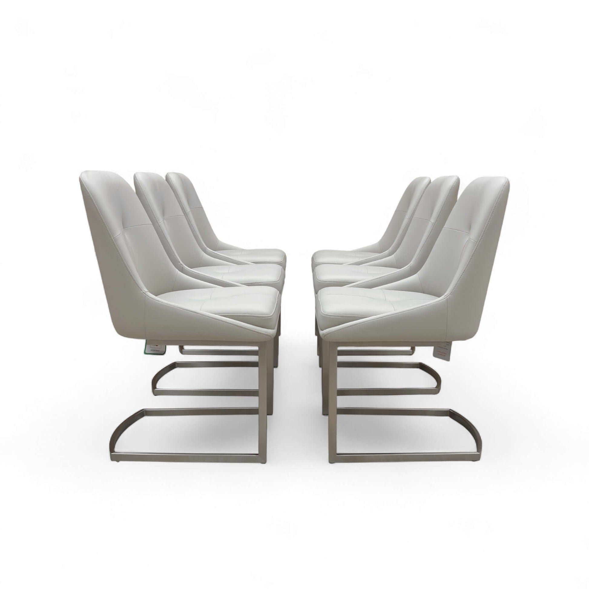 Set of modern chairs with white cushions on a white background