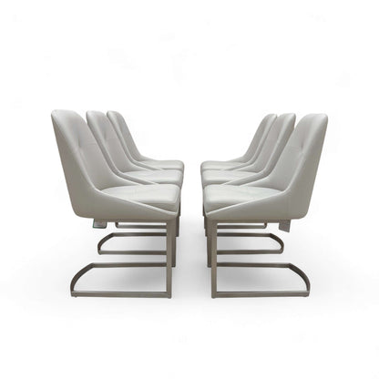 Set of modern chairs with white cushions on a white background