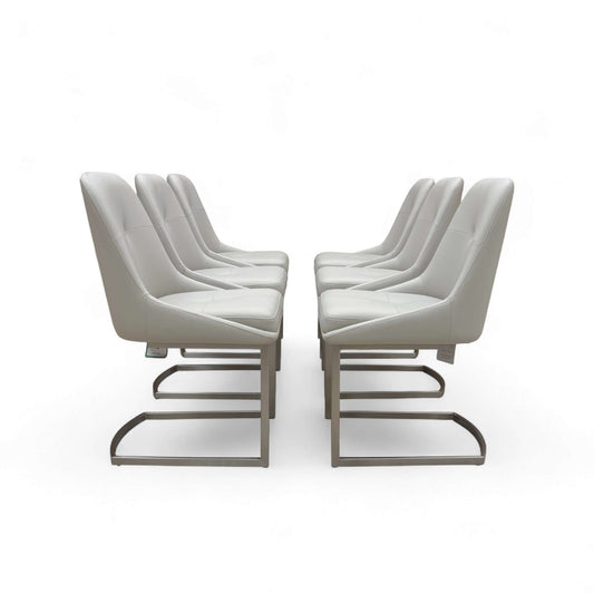 Set of modern chairs with white cushions on a white background