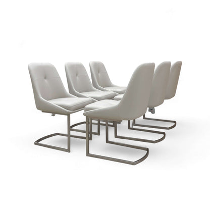 Set of six modern gray chairs with metal legs on a white background