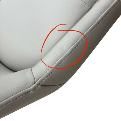Close-up of a gray leather seat with a red circle highlighting a small imperfection.
