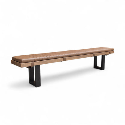 Brown leather bench with black metal legs on a white background