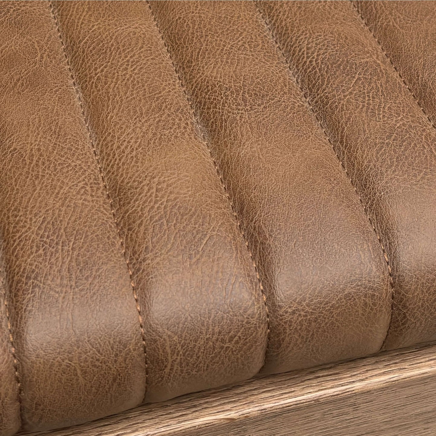 Close-up of brown leather texture with stitching details of a bench