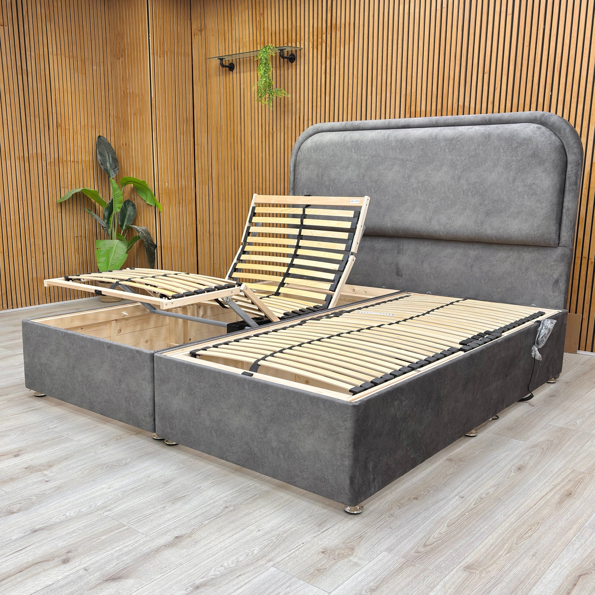 Lifestyle view of the Warwick Super King electric bed showing the plush mink velvet upholstery and floor-standing headboard design