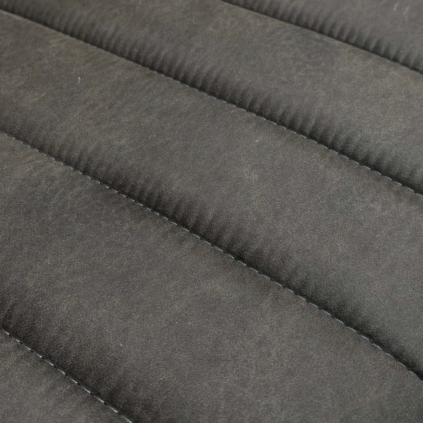 Close-up of a textured Gray fabric surface of a dining bench.