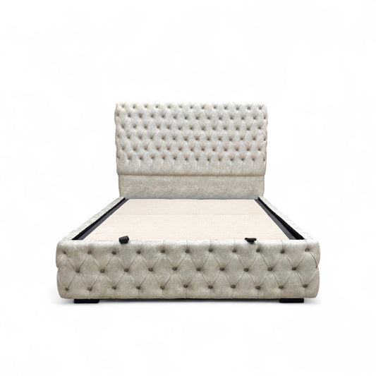 Belford Dapple Oyster Velvet King Size Bed with a tall, floor-standing headboard and end-lift ottoman storage, styled with decorative pillows.