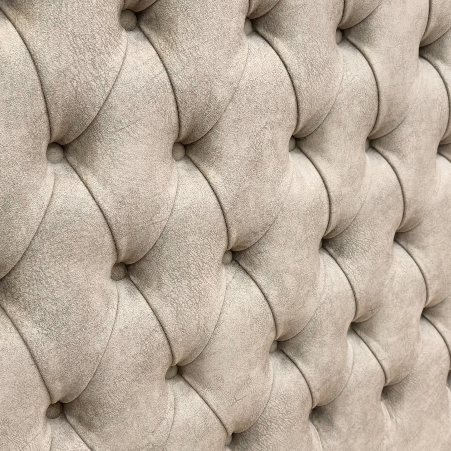 Close-up detail of the soft Dapple Oyster velvet upholstery and button-tufted stitching on the tall headboard.